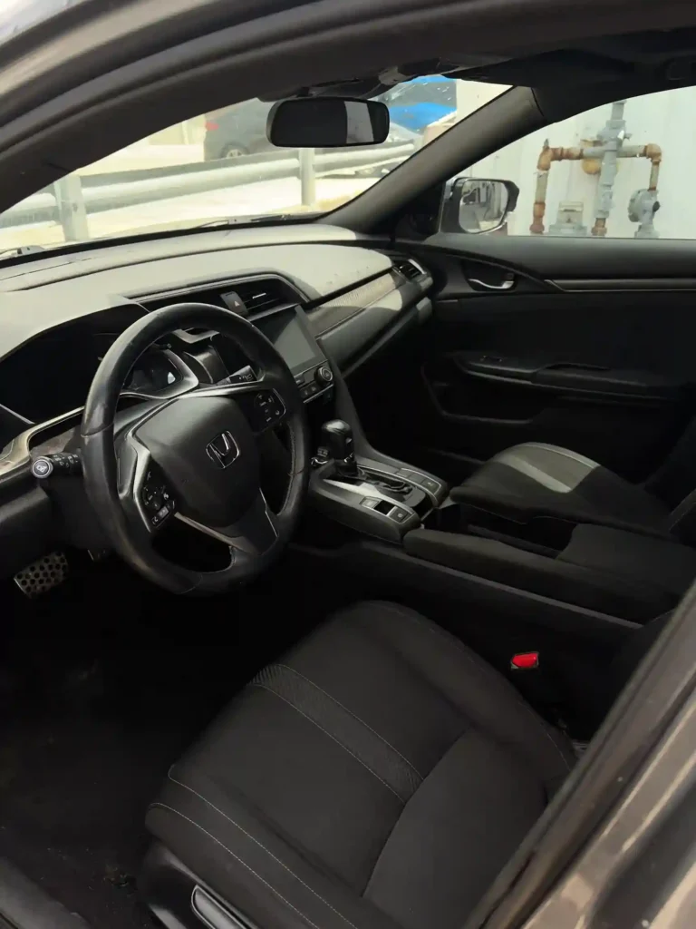 Spotless front cabin with steering wheel, dashboard, and seats after full interior detail