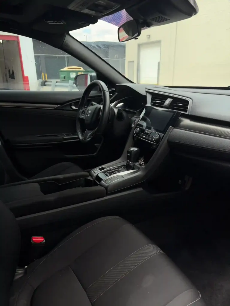 Close-up of a Honda Civic dashboard, infotainment screen, and gear shifter console