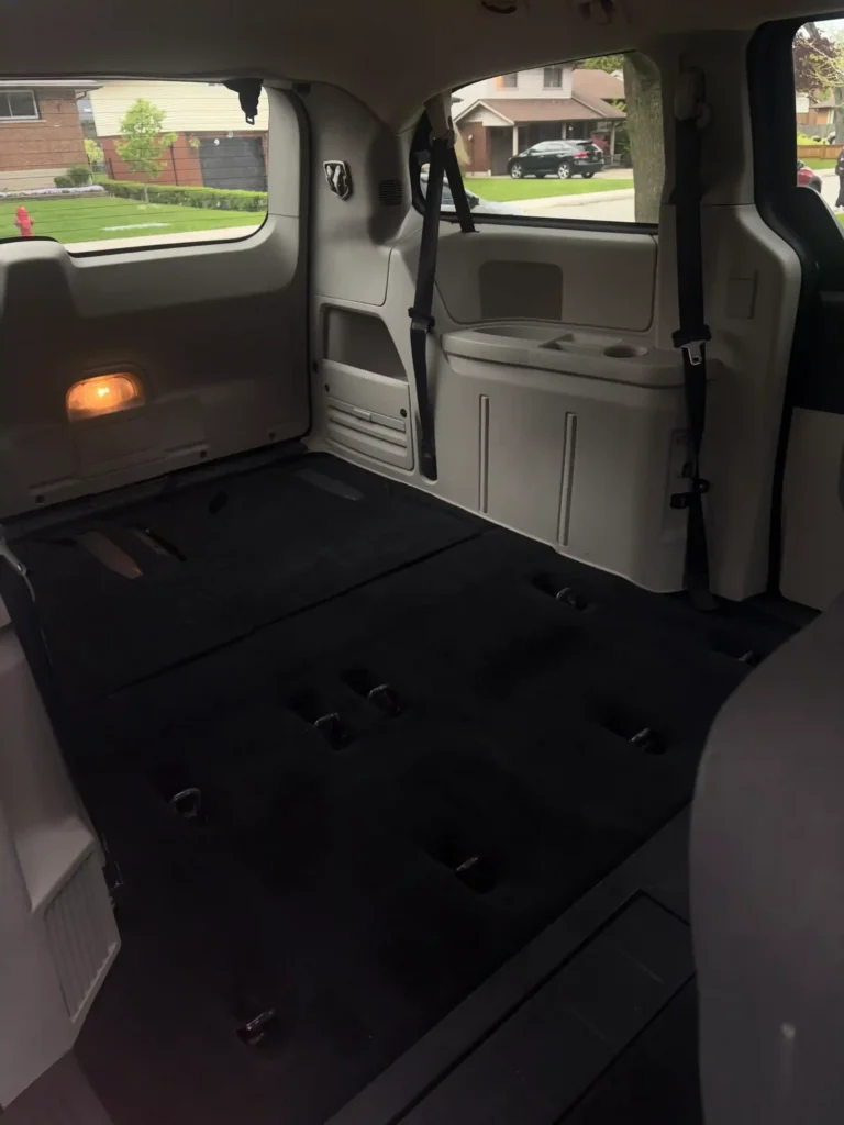 Open minivan trunk and rear cargo compartment during interior detailing 
