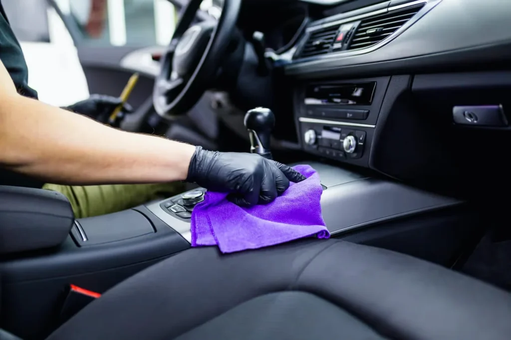 Pure Detailing technician cleaning leather interior surfaces in Hamilton ON